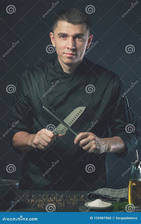 Chef Cook Holds A Knife Over Dark Grey Background Stock Photo - Image ...