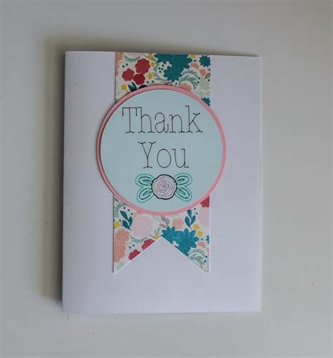 a thank you card with flowers on it and a ribbon around the corner that ...