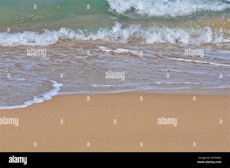 Small waves breaking at the shoreline Stock Photo - Alamy