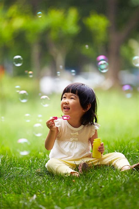 "Happy Kids Playing In The Park" by Stocksy Contributor "Bo Bo" - Stocksy