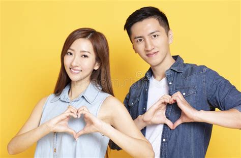 Young Couple with Heart Shape Hand Sign Stock Image - Image of ...