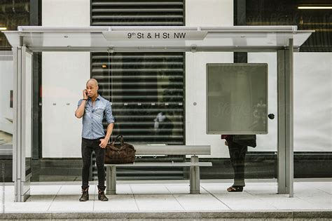 "Man Talking On Cellphone While Waiting For The Bus" by Stocksy ...