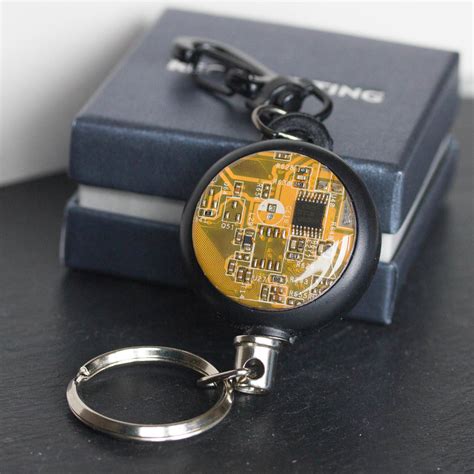 Retractable badge holder with a circuit board piece - recomputing