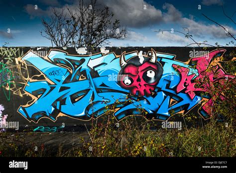 A concrete wall covered in Graffiti Stock Photo - Alamy