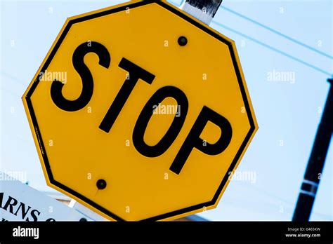 Yellow stop sign Stock Photo - Alamy