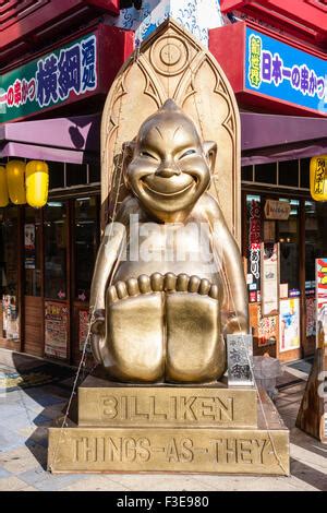 Japan, Osaka, Shinsekai. Popular Billiken statue outside restaurant ...