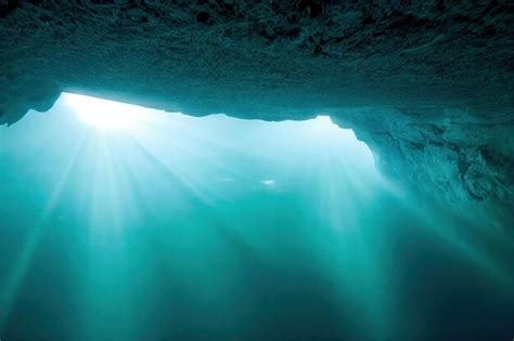 Premium Photo | Large dark underwater cave in ocean in sunlight