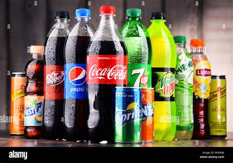 Bottles and cans of assorted global soft drinks Stock Photo - Alamy