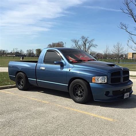 a blue pick up truck parked in a parking lot