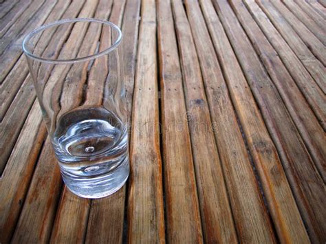 Glass on a wood table top stock photo. Image of texture - 1688996