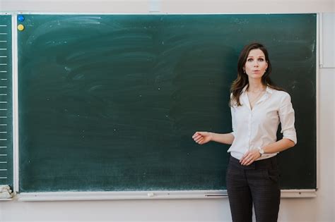 Premium Photo | Teacher pointing finger at blank board