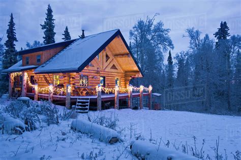 Log Cabin In The Woods Decorated With Christmas Lights At Twilight Near ...