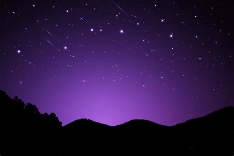 Night landscape with silhouettes of mountains and sky with stars ...