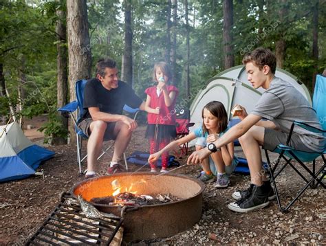 Father camping with kids Stock Photo by ©Wollwerth 63325715