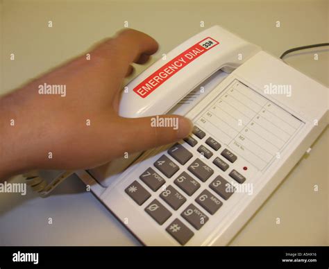 Hand grabbing telephone with Emergency sticker motion blur Stock Photo ...