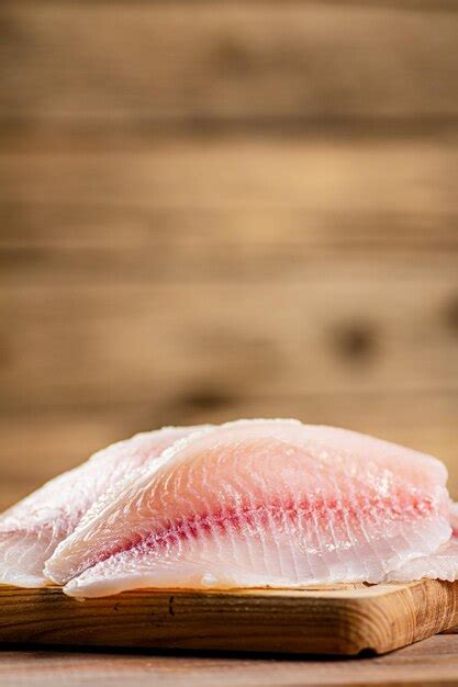 Premium Photo | Fresh fish fillet on a cutting board