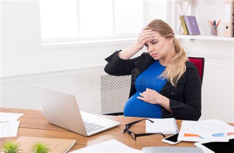 Tired Pregnant Woman Resting In Bed, Touching Her Belly Stock Photo ...