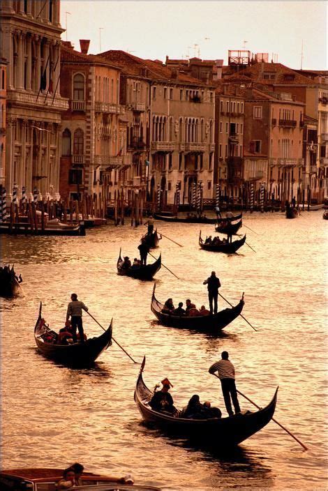 Europe. Italy. Venezia. Venice. Gondoliers ferry customers across the ...