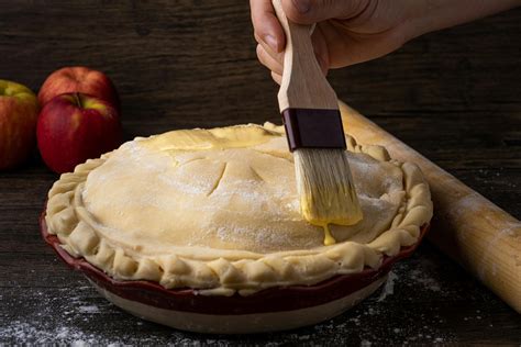 Brushing Egg Wash on a Pie · Free Stock Photo