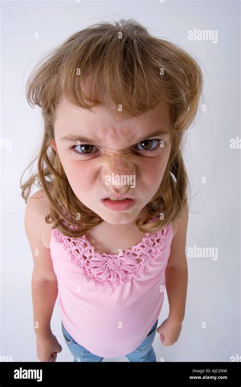 Young Girl Pulling an Angry Face at the Camera Stock Photo - Alamy