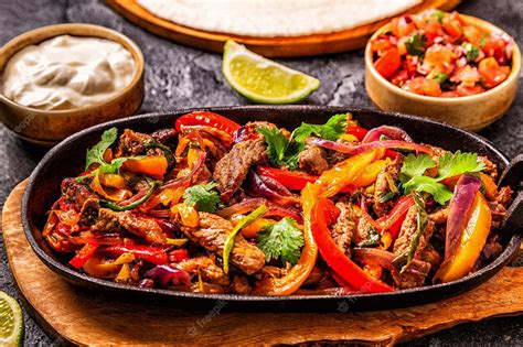 Premium Photo | Fajitas with colored pepper and onions served with ...