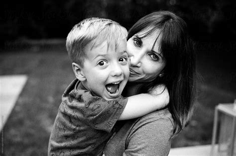 "Excited Boy Making A Happy Face While Hugging His Mother" by Stocksy ...