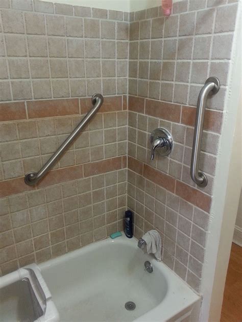 Bathroom grab bars installed in shower.