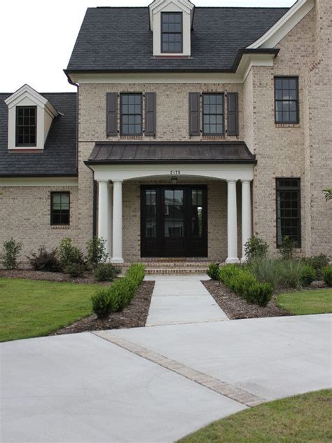 brown brick house with metal roof - Napoleon Morrell