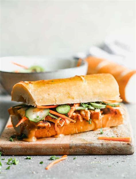 Banh mi sandwich on crusty bread, loaded with chicken, veggies and sauce.