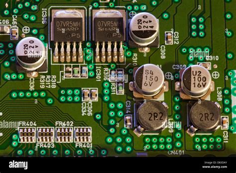 Capacitors and transistors on circuit board Stock Photo - Alamy