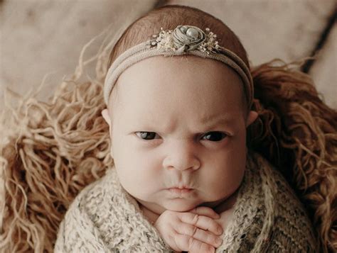 This baby's grumpy face during her newborn photo shoot is totally adorable