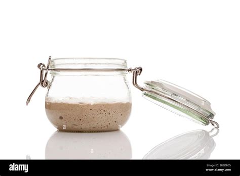 Home made starter yeast growing in a glass jar isolated on white ...