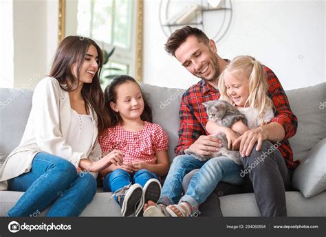 Happy family with cute cat resting at home Stock Photo by ©serezniy ...