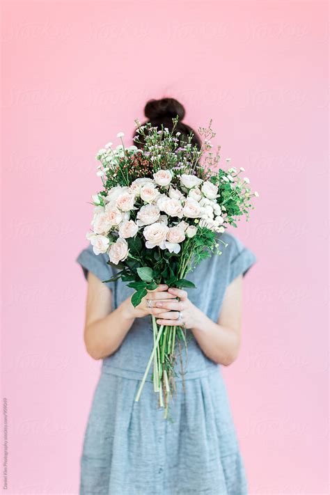 "Girl Holding Flowers In Front Of Colorful Wall" by Stocksy Contributor ...