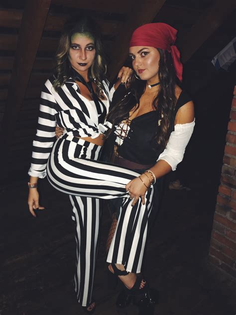 two women dressed in pirate costumes posing for the camera