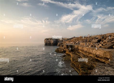 Rocky cliff landscape with sunset over ocean Stock Photo - Alamy