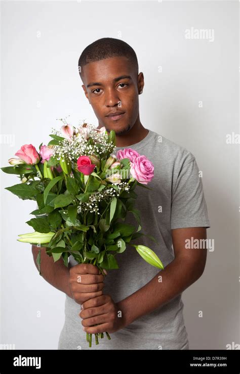 Guy Holding Bunch of Flowers Stock Photo - Alamy