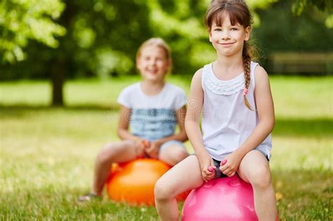 Two Girls Bounce with Bouncy Ball Stock Image - Image of kindergarten ...