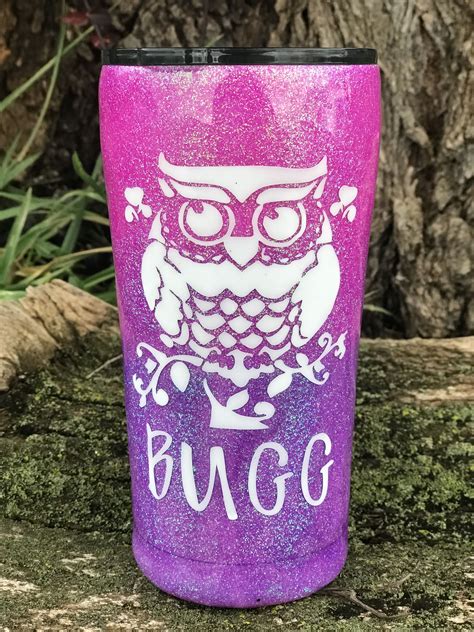 a purple glitter tumbler with an owl on it and the words bugg written ...