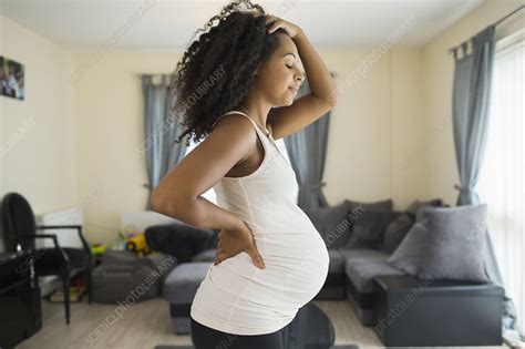 Tired pregnant woman in living room - Stock Image - F028/7732 - Science ...