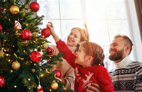 Happy Family Mother, Father and Child Daughter Decorate Christmas Tree ...