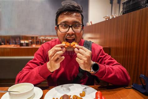 Indian Man Eating Chicken Wings at a Cafe Stock Photo - Image of dinner ...