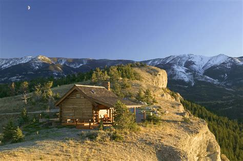 A Small Log Cabin Perched Cliffside in Montana