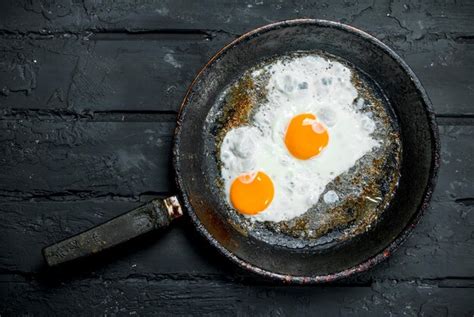 Premium Photo | Fried eggs in a frying pan