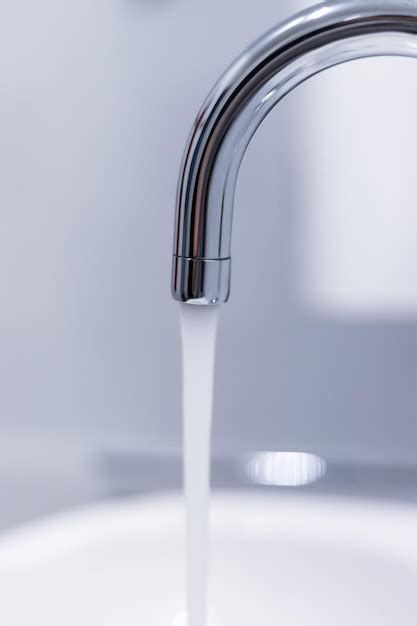 Premium Photo | Saving water close up of spigot with clear flowing water