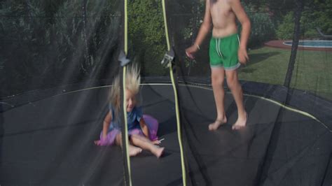 Kids playing on trampoline viewed through safety net 42474203 Stock ...