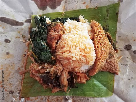 Padang rice or "Nasi Padang" with rice siram broth, side dishes of ...