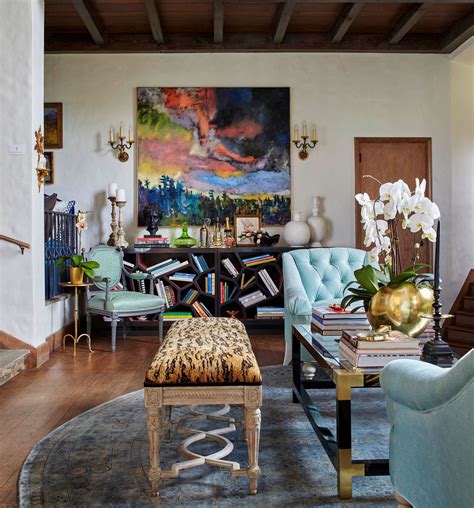 a living room filled with furniture and a painting on the wall