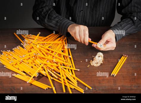 Man sharpening pencils with a pencil sharpener Stock Photo - Alamy