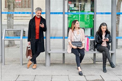 "People Waiting For A Bus" by Stocksy Contributor "Ivan Gener" - Stocksy